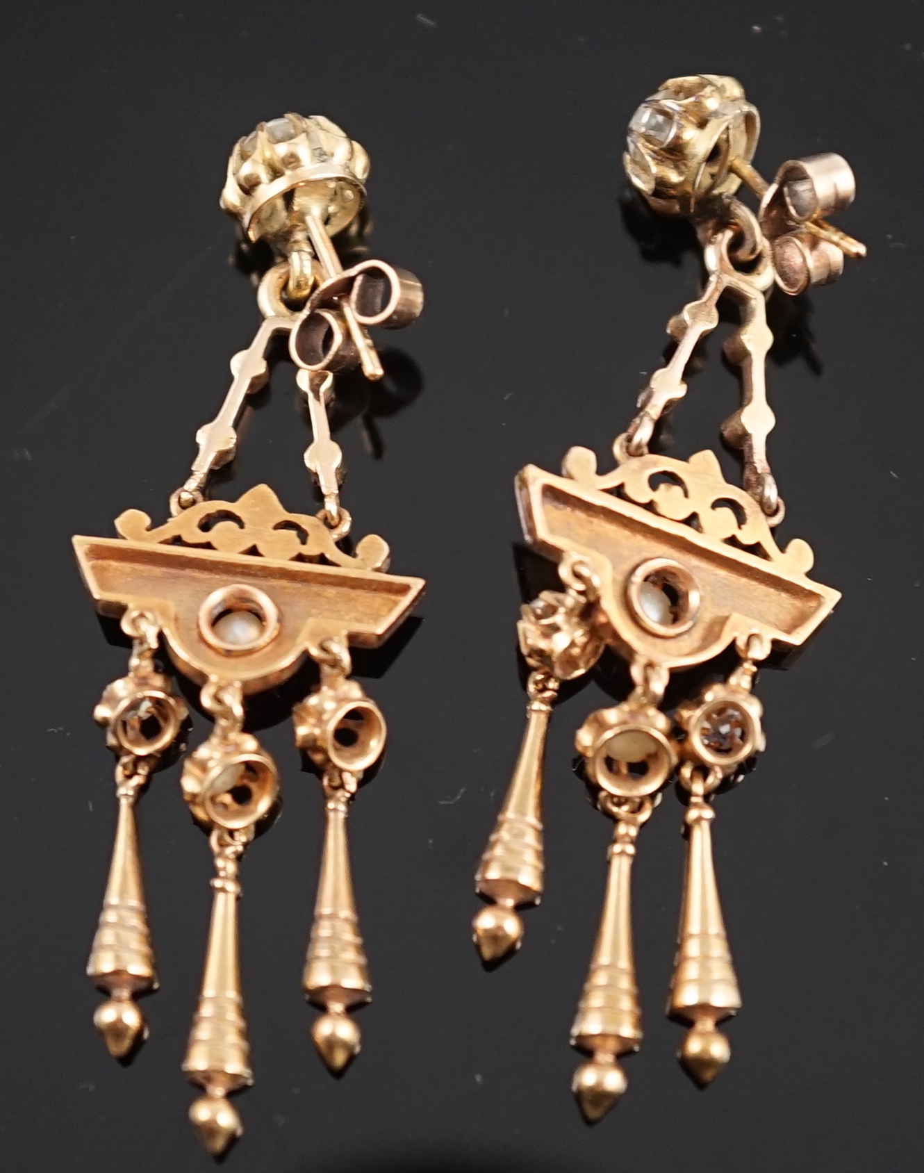 A pair of Victorian gold, seven stone diamond and two stone pearl set triple drop earrings, of aesthetic design